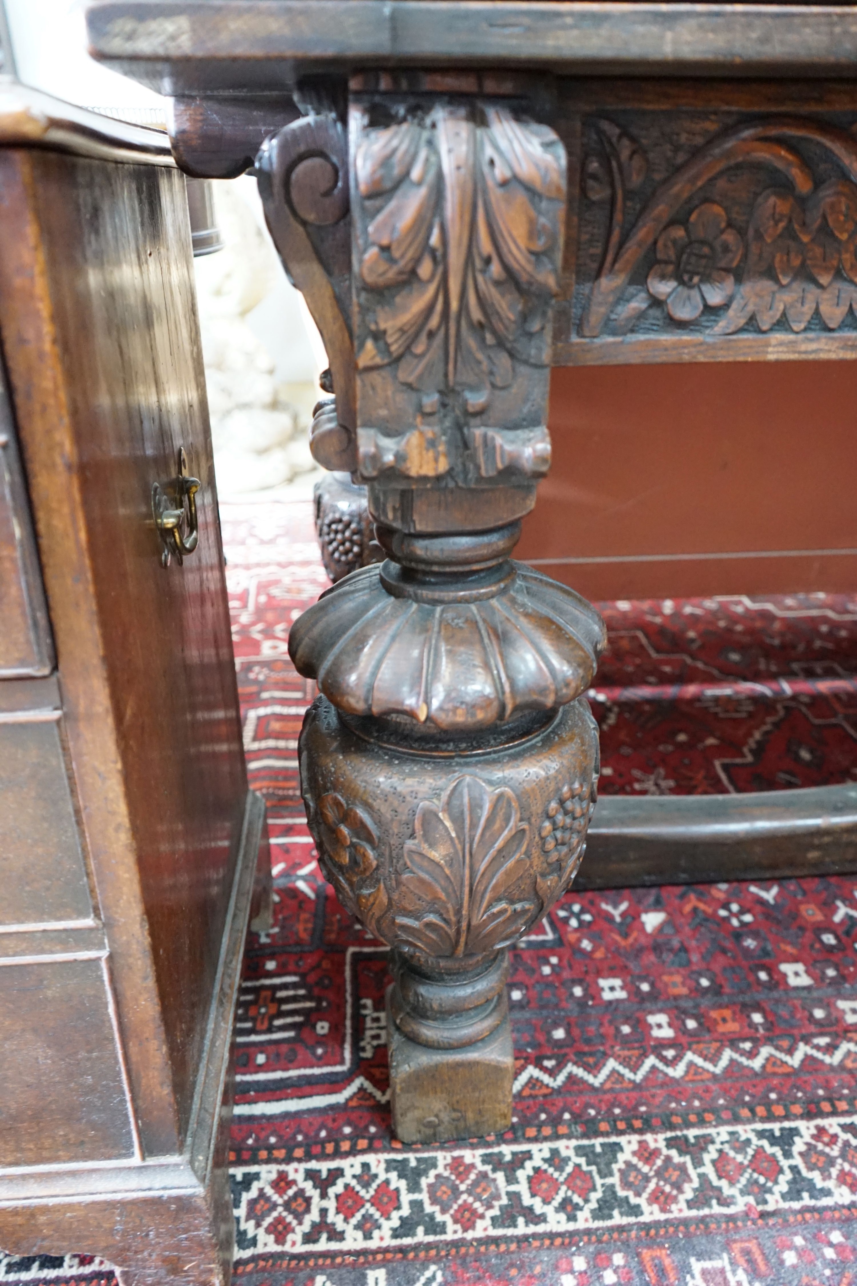 A 17th century style rectangular oak draw leaf dining table on carved baluster legs, 275cm extended, width 76cm, height 77cm